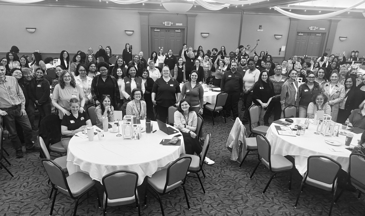 Large group of conference attendees gathered together in a meeting room