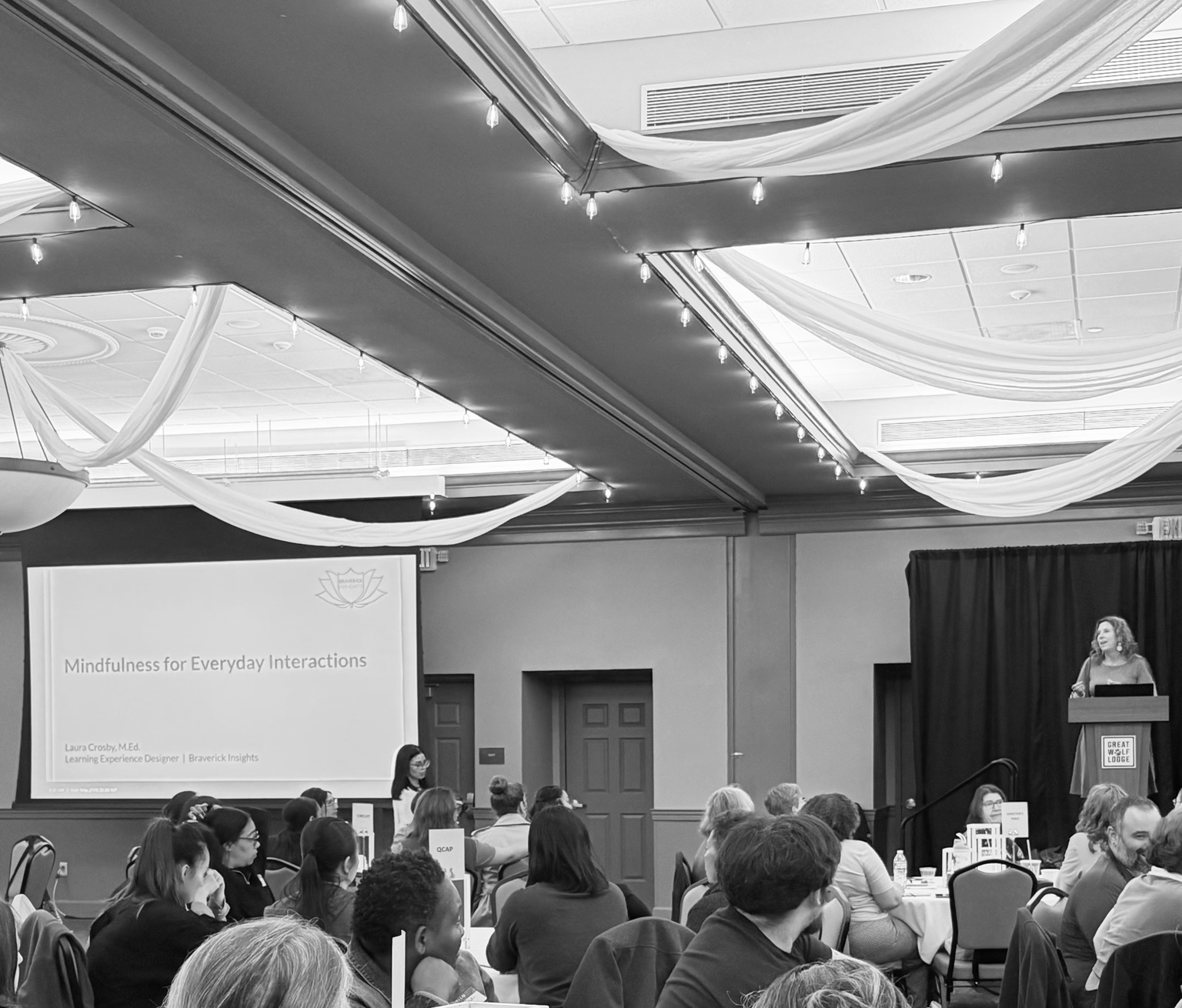 Laura Crosby leading an interactive learning session for a large audience